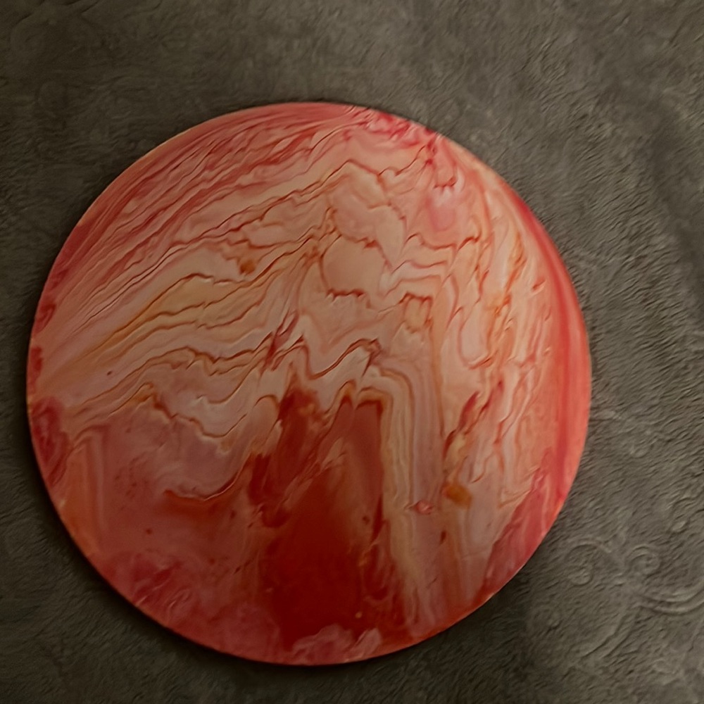 Hand painted orange in color. Paint Pour unfinished back.
